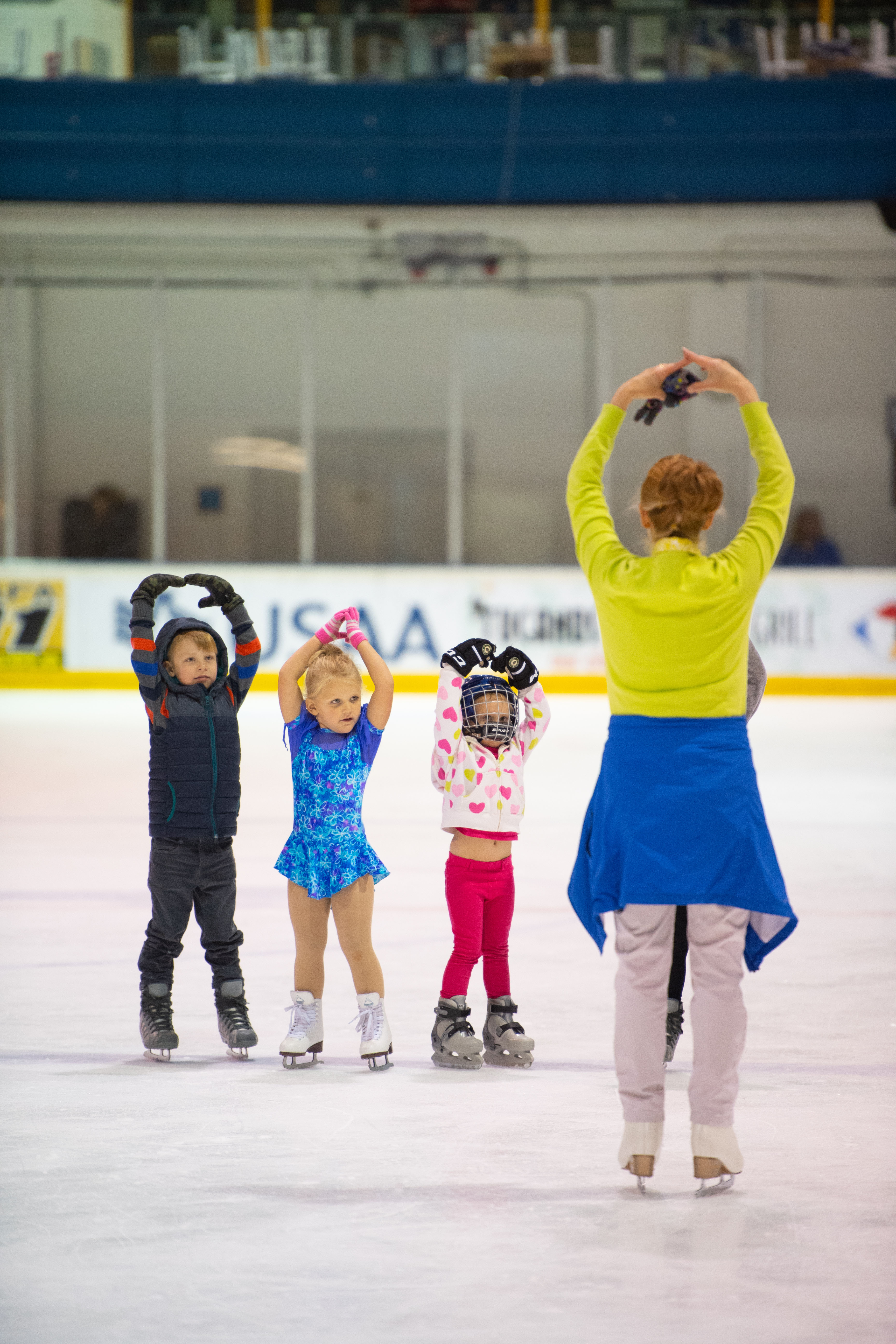 Preschool age skaters in a lesson with a coach